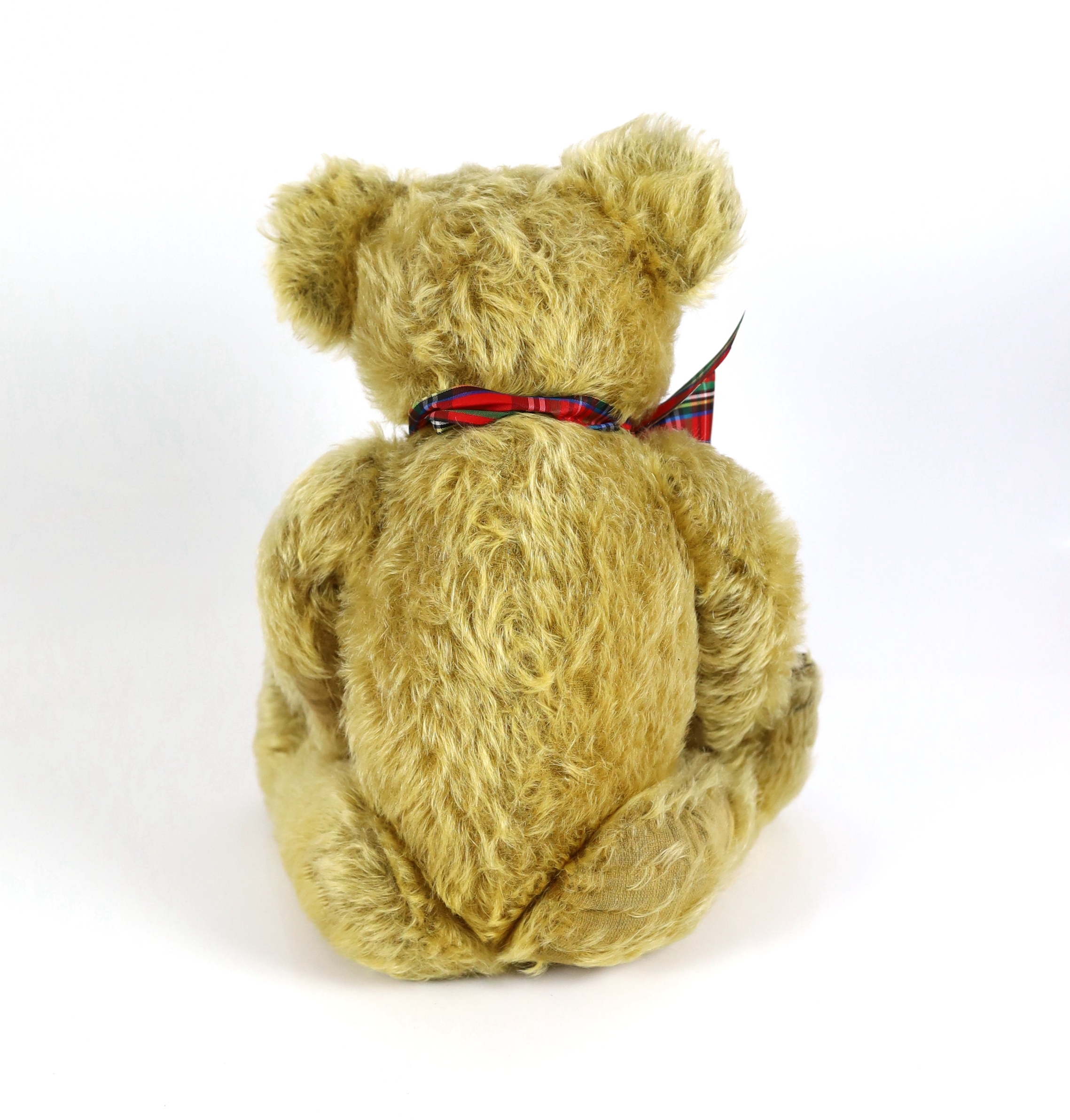 A 1930's Merrythought bear, with label, 44cm, old repair to foot, some hair loss